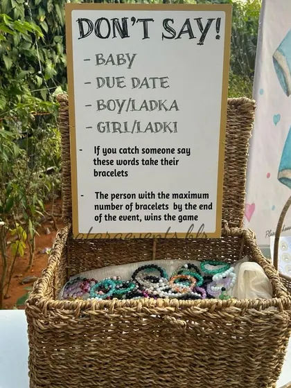 The "Don't Say Baby" game basket at a baby shower. This is a fun and simple icebreaker that I often recommend to get guests mingling and laughing.