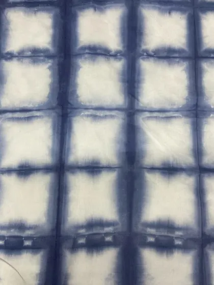 Another example of a square grid tie-dye pattern, this time in a vibrant indigo blue.
