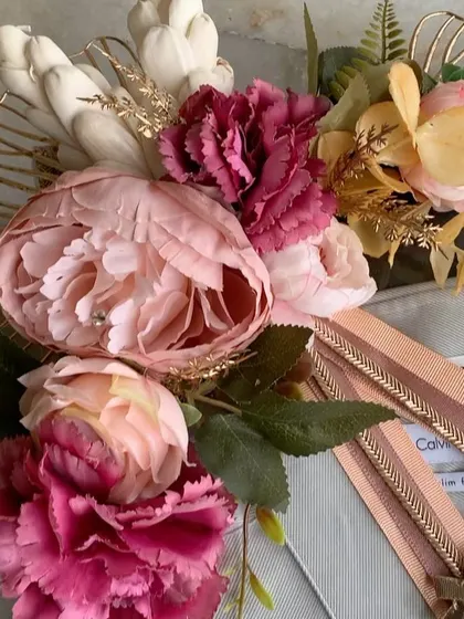 A close-up of the floral decoration on a trousseau gift. We use a mix of peonies, carnations, and sola wood flowers to create a lush and luxurious feel.