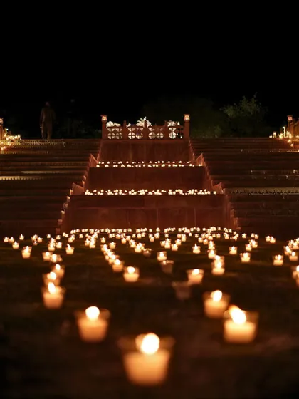 The grand, candlelit steps of Suryagarh leading up to the Sangeet venue, creating a dramatic and impressive entrance for guests.