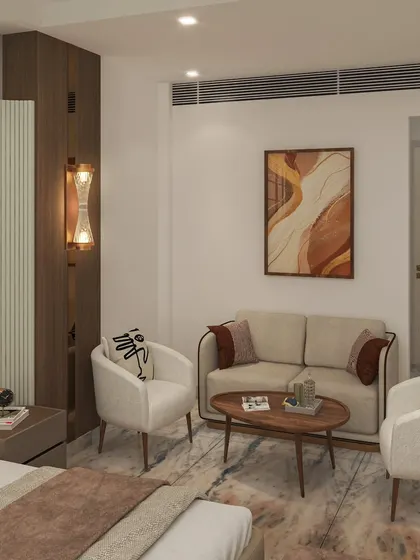 A cozy seating area within the master bedroom, featuring two comfortable armchairs and a small coffee table, perfect for morning tea or quiet reading.