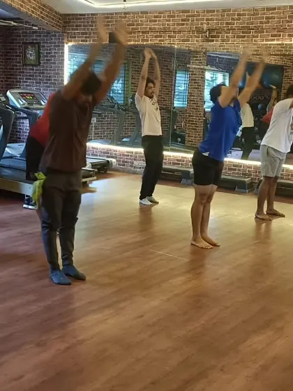 Members moving through a sun salutation sequence, a key part of our dynamic yoga flow sessions.