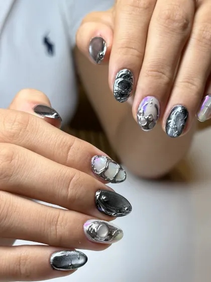 This photo shows the 3D chrome nails in a different light, highlighting the pearlescent base and the way the metallic elements catch the light.