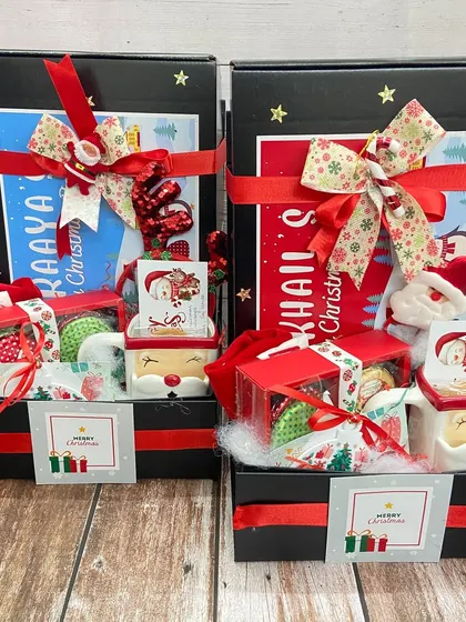 Personalized Christmas hampers for kids, complete with their names, Santa mugs, and other festive treats to make their holiday season magical.
