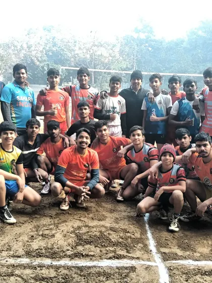 The team posing for a photo after a tough practice session during the summer camp. The smiles show their love for the sport.