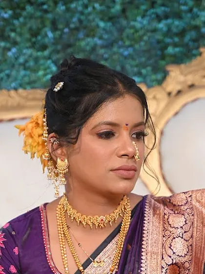 A close-up of the bride's Vidhi look in a purple saree. The makeup is soft and ethereal, with a focus on her glowing skin.