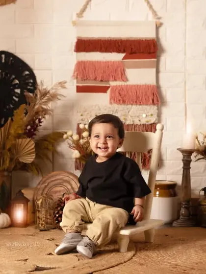 A simple, beautiful portrait of a one-year-old boy sitting contentedly in our cozy boho studio.