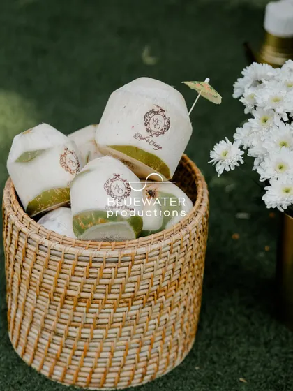 A personal touch for a summer event: fresh coconuts are branded with the couple's custom wedding monogram.