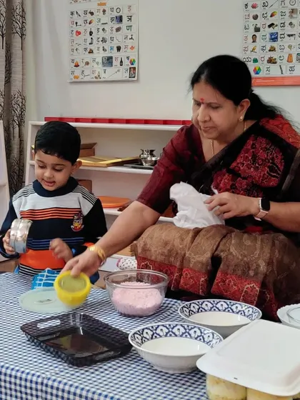 An instructor guides a child through the steps of a no-fire cooking recipe. I demonstrate the process, then step back to let the child explore and work independently, offering support only when needed.