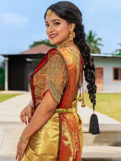 This over-the-shoulder shot highlights the traditional braid hairstyle. While my main course is makeup, I emphasize the importance of the complete look, including classic hairstyling.