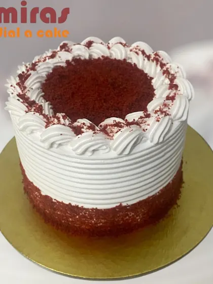 My classic red velvet cake is a crowd-pleaser. It features a moist, velvety crumb and is generously layered with smooth, tangy cream cheese frosting, finished with simple and elegant piping.