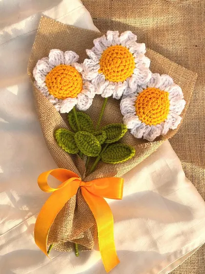 Chasing daisies and dreams. A simple, beautiful bouquet of three crochet daisies wrapped in rustic jute fabric.
