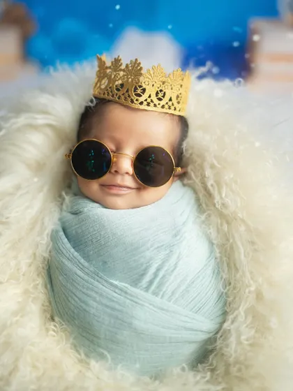 A close up of our cool little prince, rocking his sunglasses with a tiny smile. This shot is full of personality.