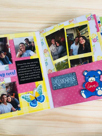 An inside page of the scrapbook, showing a collage of photos, a personal message, and cute embellishments like a teddy bear and butterfly.