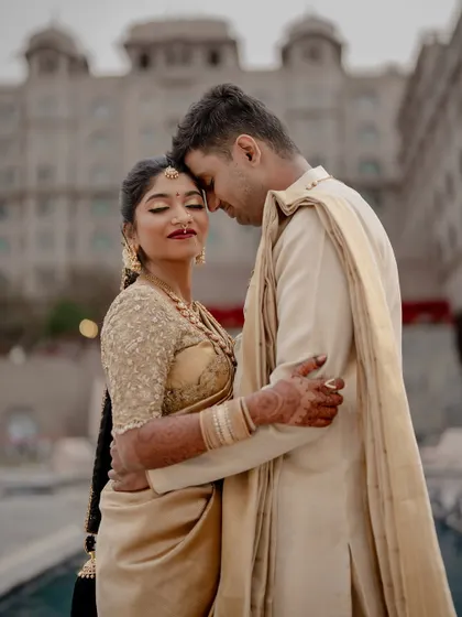 A classic portrait at a destination wedding, with the couple in elegant gold attire reflecting the grandeur of the venue. We excel at blending tradition with magnificent settings.