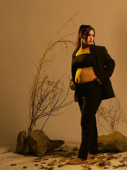 Another angle from the modern, edgy studio shoot, this portrait captures a look of confidence and strength, blending contemporary fashion with maternity photography.