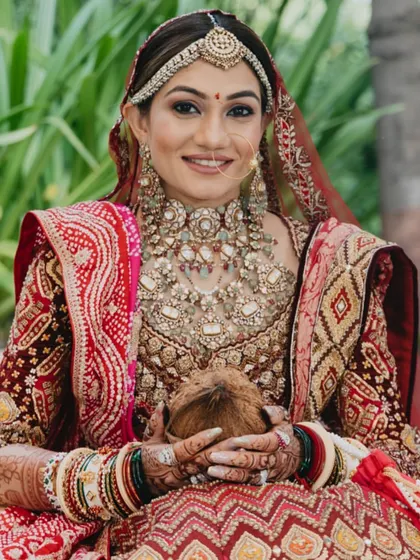 A portrait of the beautiful bride holding the sacred coconut, an essential part of many Indian wedding rituals, symbolizing purity and prosperity.