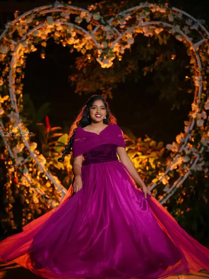 A magical moment captured in this beautiful wine-colored gown. The off-shoulder design and flowing skirt are perfect for a romantic evening photoshoot.