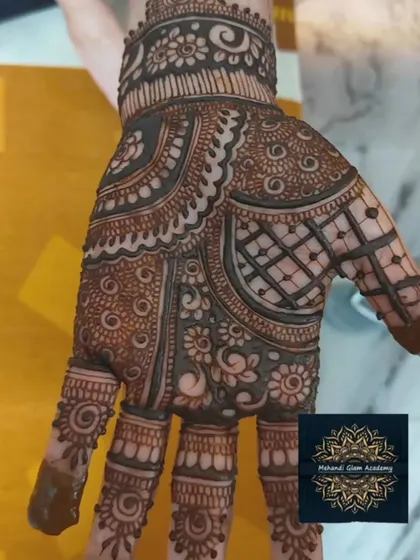 A full, dark-stained mehndi design on the back of the hand. This showcases the beautiful result after the henna paste is removed.