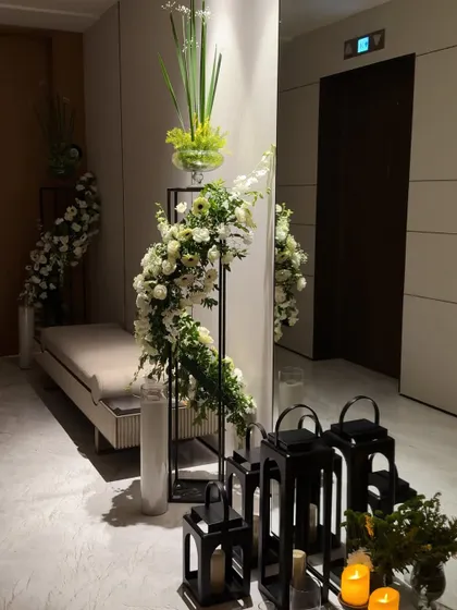 A slightly different angle of the entryway decor, showing the warm light from the candles inside the black lanterns.