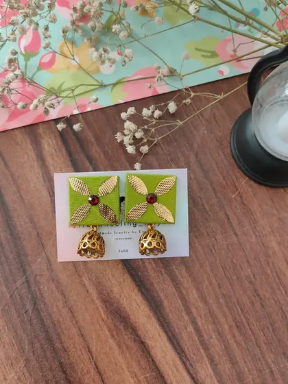 My gotapatti earrings are a festive favorite. These square fabric studs feature golden gotapatti work and a small jhumki drop, available in brown, green, and grey.