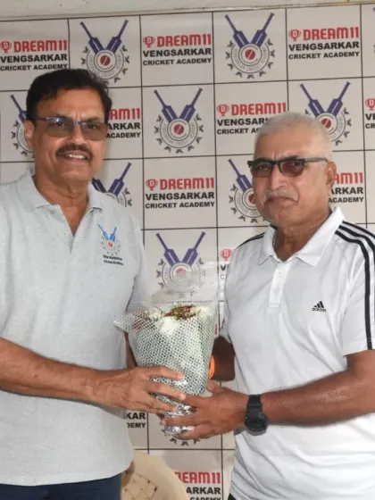 Presenting a bouquet to former cricketer Sanjay Gaitonde at the Dream11 Cup event.