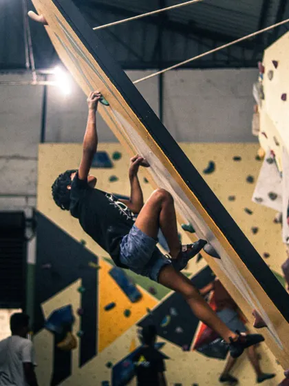 A climber practices body tension and foot placement during a workshop. Learning these core principles early is key to climbing efficiently and preventing injury.