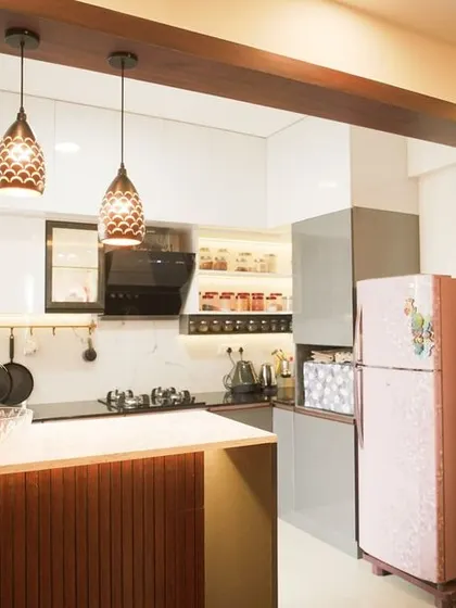 Another angle of the open-plan kitchen, showing the custom puja unit designed to match the home's interior style. This demonstrates our ability to create holistic designs that cater to all aspects of our clients' lives.