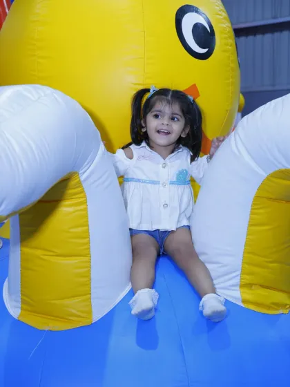 A huge smile from a toddler enjoying the giant inflatable octopus structure.