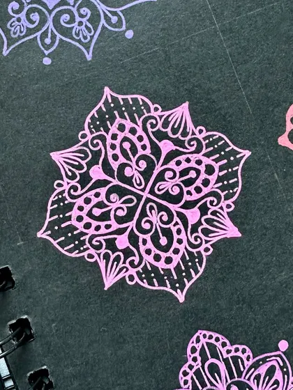 A pink mini mandala with intricate details, perfect for practice.