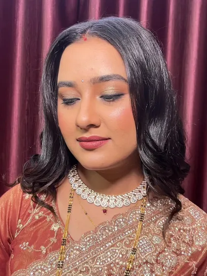 A close-up of the eye makeup. The soft, blended eyeshadow and defined liner create a look that is both glamorous and understated.