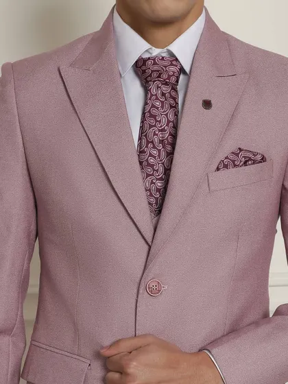 A detailed shot of our pastel pink suit, paired with a matching paisley tie and pocket square.
