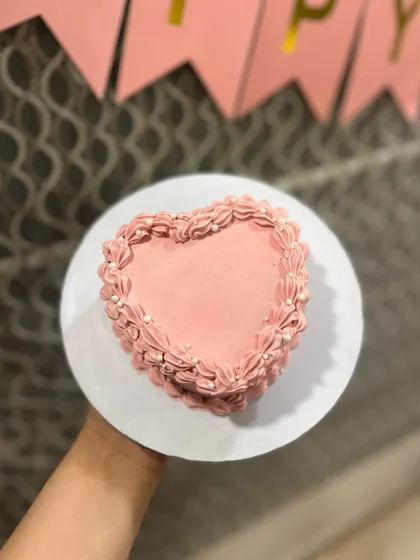 An overhead view of our heart-shaped bento cake, showing the delicate shell border piping.