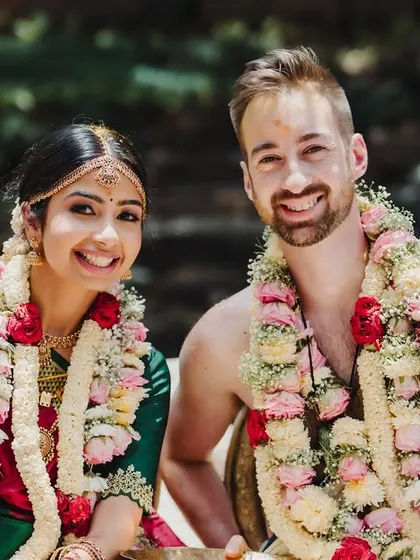 A happy, smiling portrait of a cross-cultural couple, their joy evident as they celebrate their union.