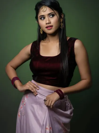 A three-quarter shot, showing the model's pose and the details of her outfit.
