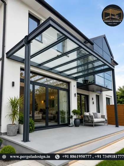 This expansive glass pergola creates a luxurious all-weather patio. Attached to the house, it extends the living area outdoors, providing a sophisticated space for dining and lounging with an open view of the sky.