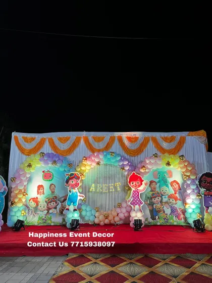 A wide shot of the Cocomelon stage decor, showing how all the elements come together to create a fun and cheerful atmosphere for a child's birthday.