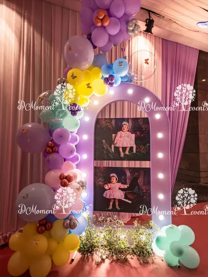 Another version of the illuminated photo arch, this time with different photos and a whimsical arrangement of pastel balloons.