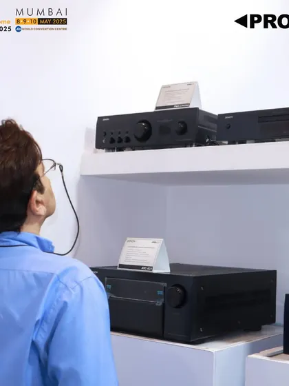 A visitor at our Smart Home Expo 2025 booth in Mumbai, exploring our range of Denon amplifiers. Our presence at Asia's largest smart home expo is focused on sharing our legacy of excellence.