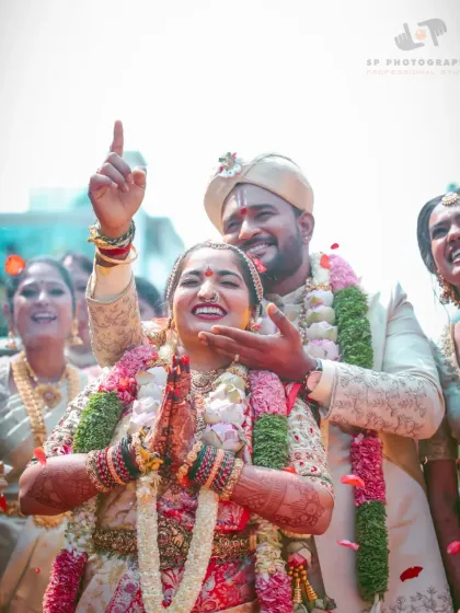 A jubilant moment right after the ceremony. The couple's triumphant and happy expressions, surrounded by family, perfectly capture the celebratory spirit.
