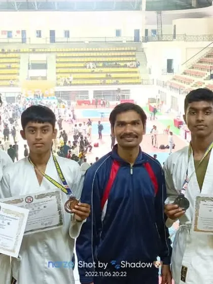 A group photo with my medal-winning students at the Koramangala indoor stadium during the 2022 state championship.