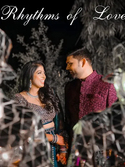 A creative Sangeet portrait taken through mirrored decor. This shot adds an artistic and modern touch, reflecting the couple's smiles and the vibrant atmosphere of the night.