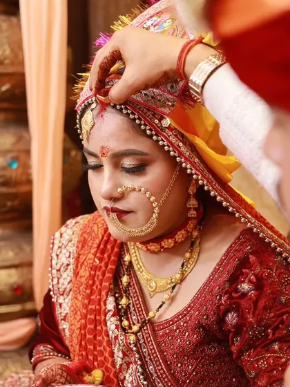 A close-up of a traditional Pahadi bride, highlighting the unique Nathuli and other cultural jewelry. We have experience capturing the specific details of regional weddings.
