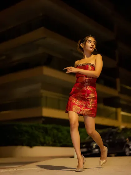 Anushka Sen walking the streets of Cannes at night in her red Banarasi after-party dress. A perfect blend of Indian heritage and modern glamour.