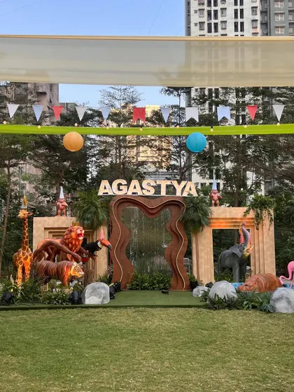 For this 'Wild Two' jungle themed birthday, we created a massive custom stage with marquee letters, a waterfall feature, and life-sized animal props to serve as the perfect backdrop for the celebration.