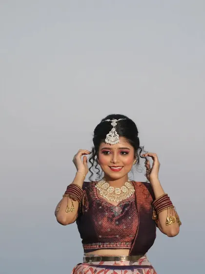 A beautiful portrait of a client in a traditional printed lehenga.