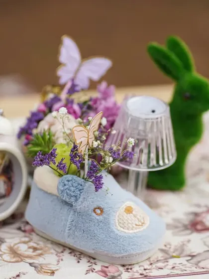 Tiny, thoughtful details like a baby shoe used as a vase, a miniature lamp, and a small clock, all contributing to the enchanting theme.