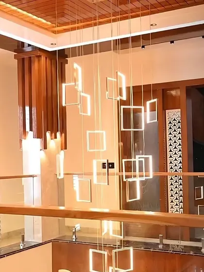 A magnificent multi-story chandelier, fully automated to control its brightness. It serves as a stunning centerpiece in this villa's open staircase area.