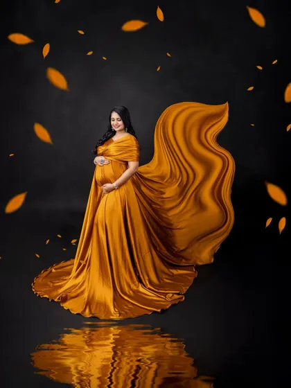 The reflection on the floor perfectly mirrors the flowing golden gown, creating a symmetrical and artistic composition.