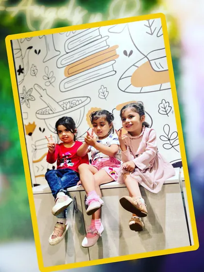Friends that play together, stay together. Three little angels taking a quick break from the fun to pose for a picture in front of our illustrated cafe wall.